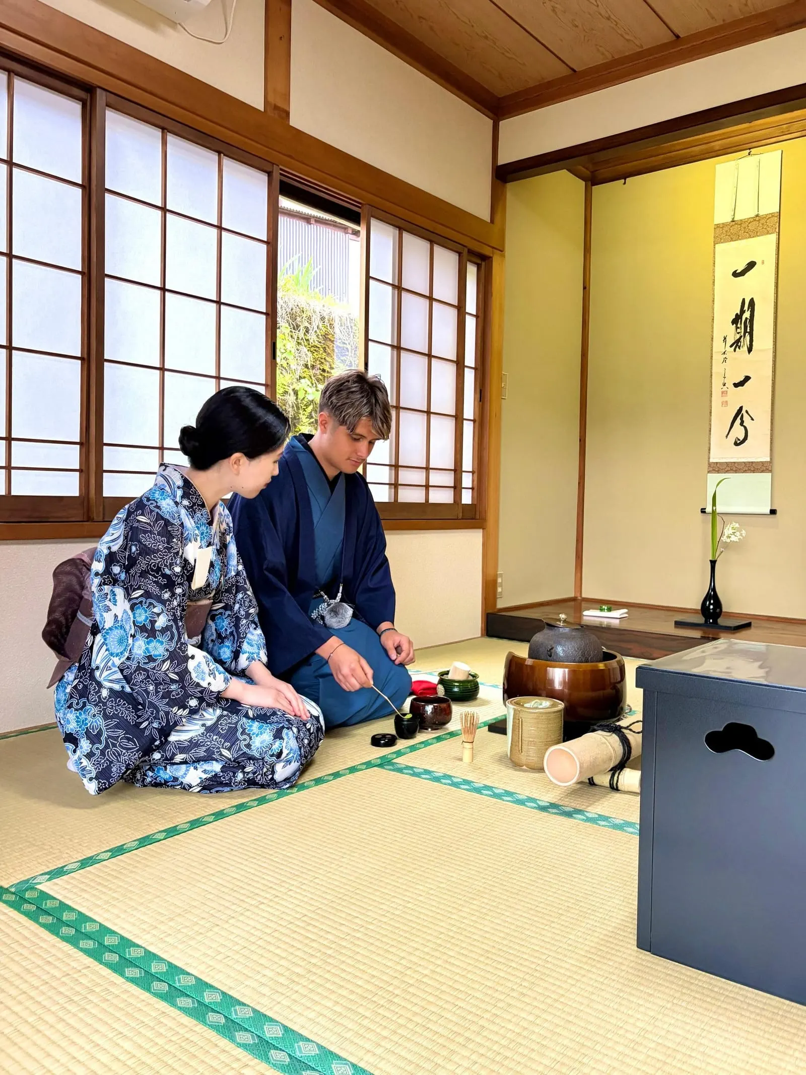 The host preparing matcha in the tatami tea room