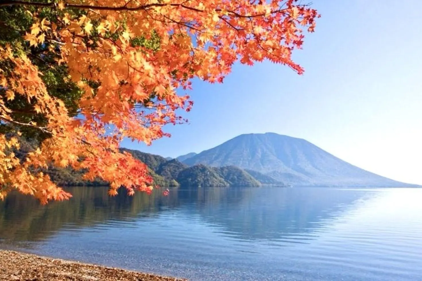 Mount Nantai across Lake Chuzenji, framed by maple leaves